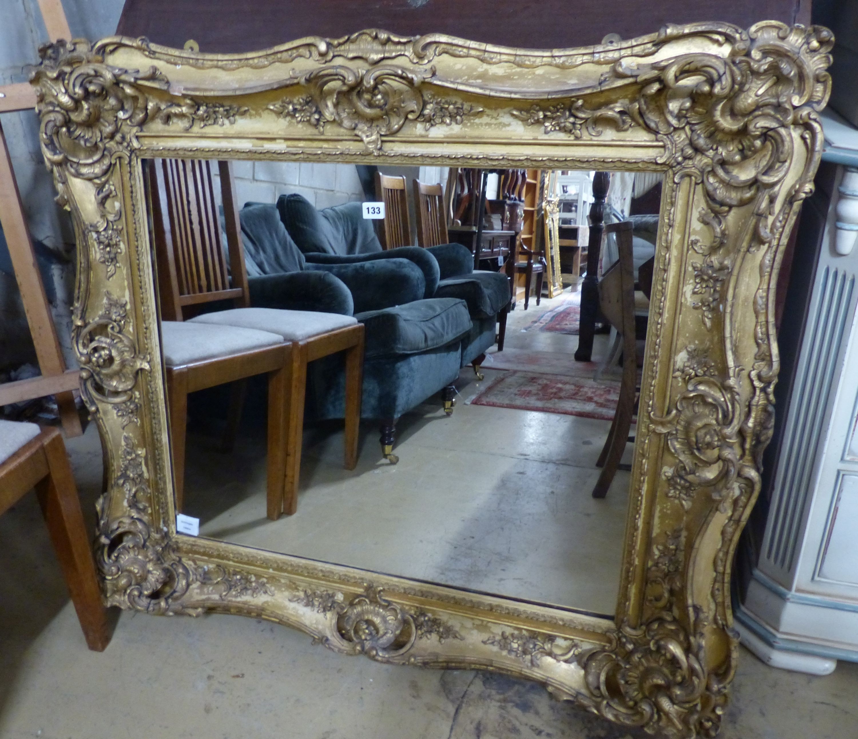 A Victorian giltwood and gesso rectangular wall mirror, (formerley a picture frame), W.110cm H.102cm